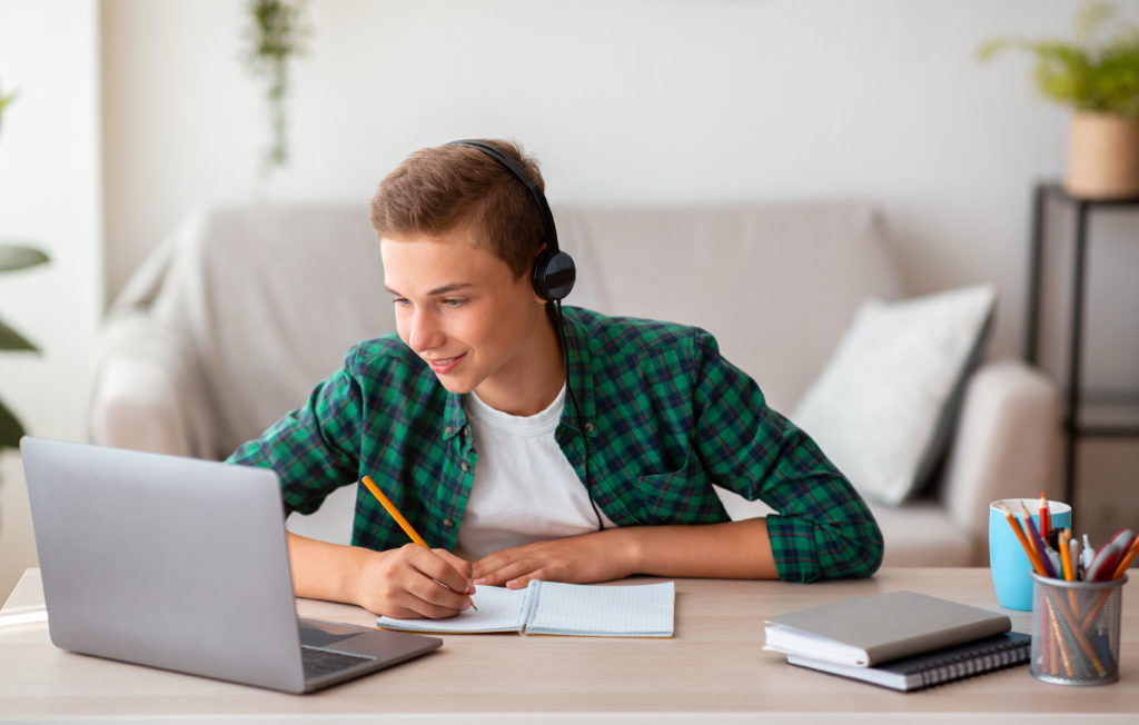 Teenage male student studying english