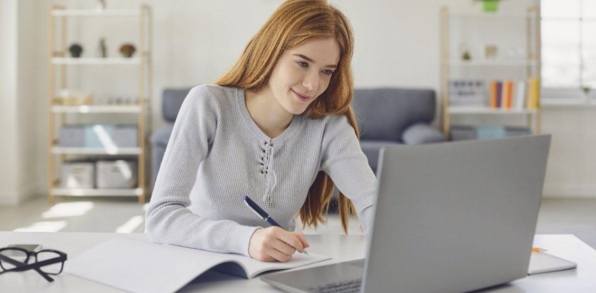 Student using a tuition service through laptop at home