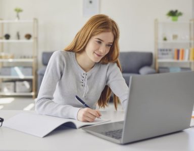 Student using a tuition service through laptop at home