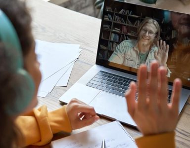 Student interacting with online tutor on laptop screen