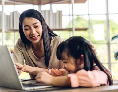 Mother and child setting learning together on a laptop
