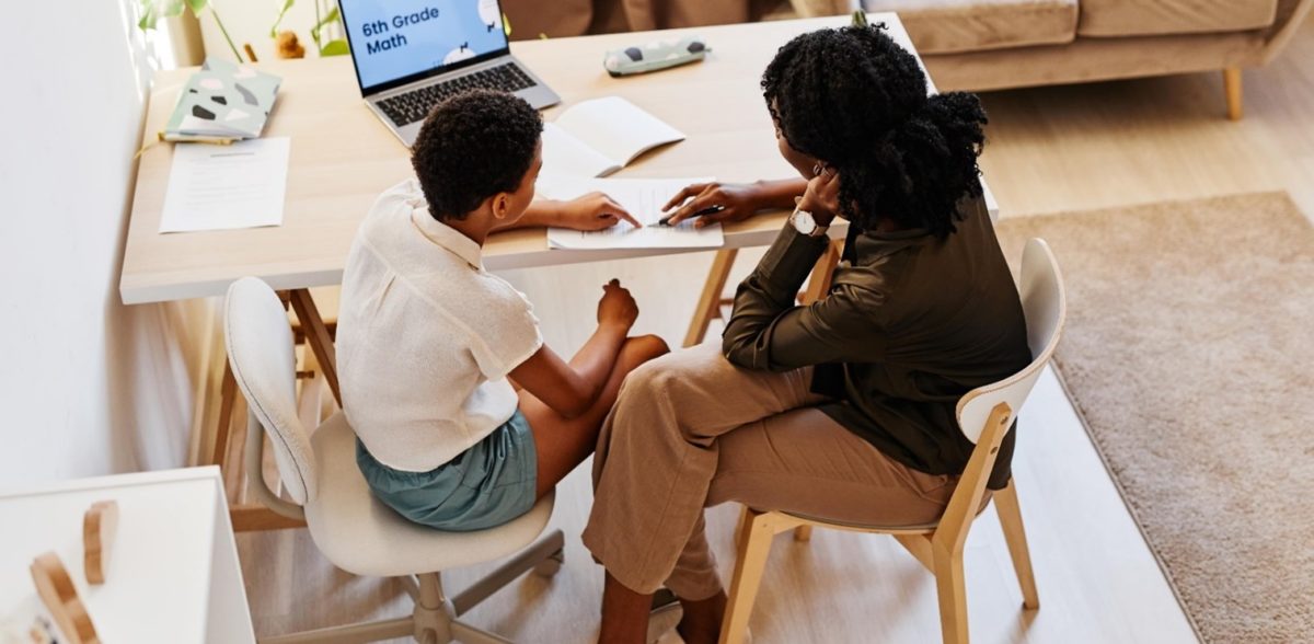 Teacher supporting child with 6th grade math